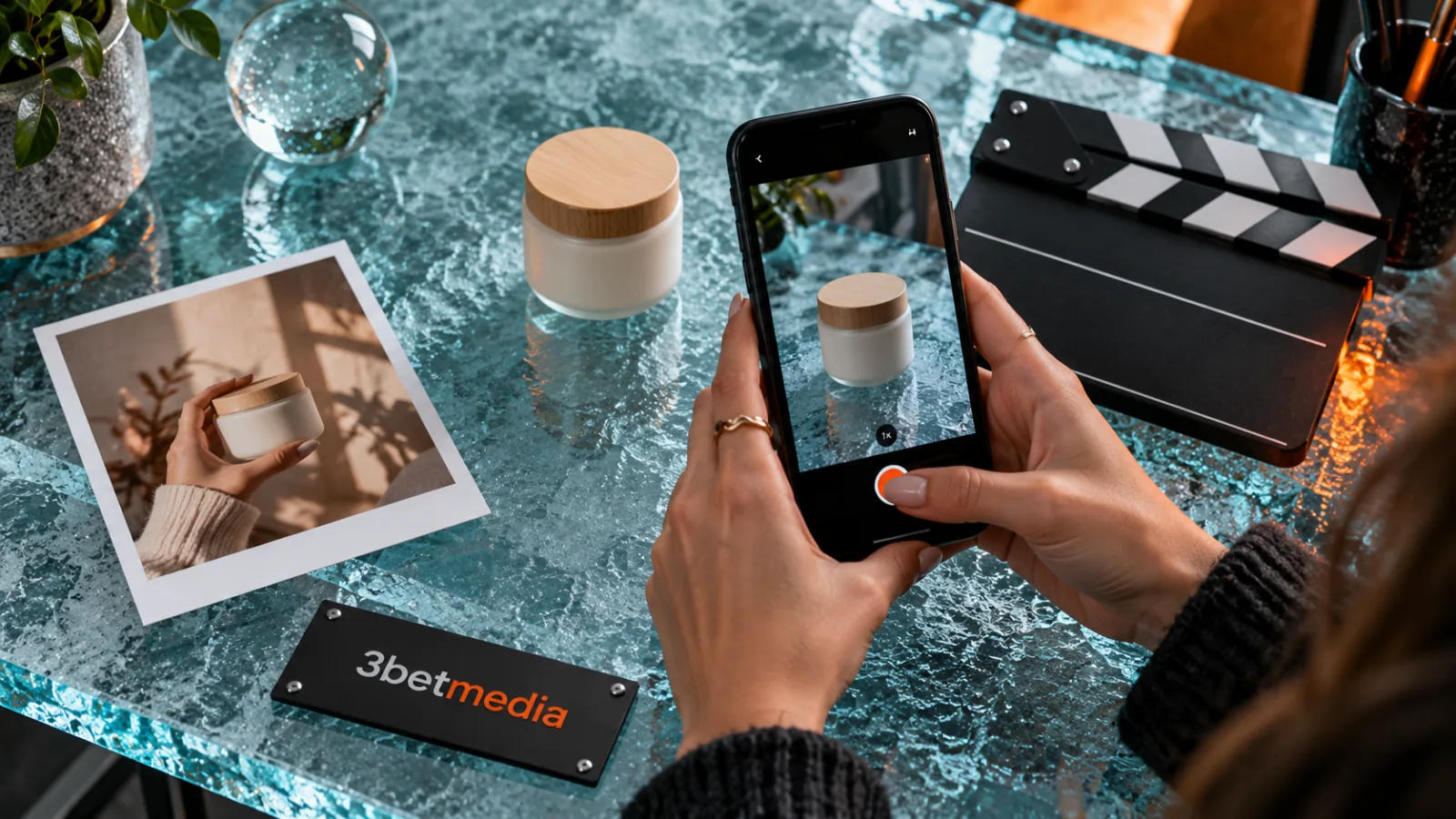 Adult hands filming a plain product beside a customer photo and a production clapperboard